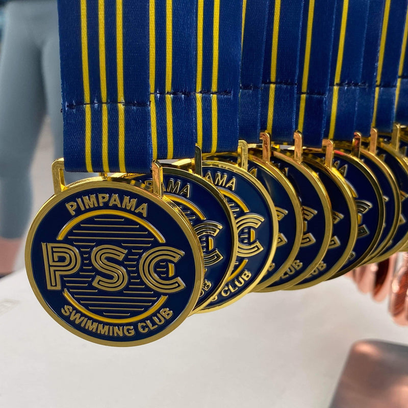Custom zinc alloy medals with shiny finish and sublimated ribbons created by Miklin & Co for Australian sports clubs